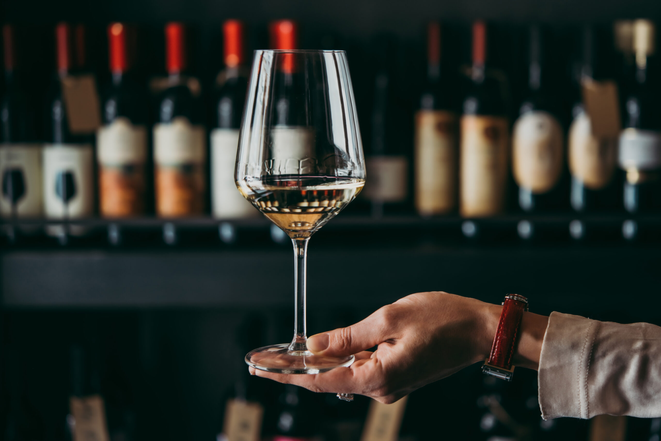 Hand holding a wine glass.